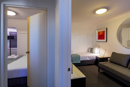 a view of a hotel room with a couch and a bed