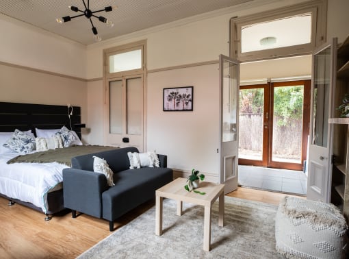 a bedroom with a bed and a couch and a coffee table