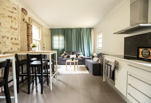 a living room with a kitchen and a couch and a table