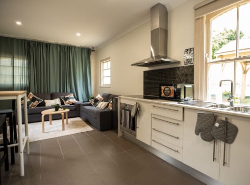 a living room with a kitchen and a couch and a table