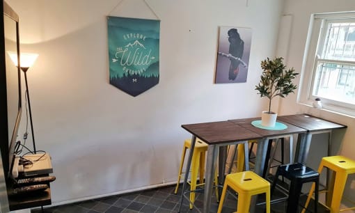 a dining room with a wooden table and yellow stools