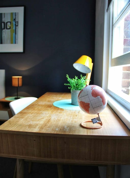 a wooden table with a globe on top of it