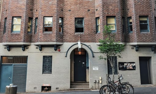 two bikes parked in front of a brick building
