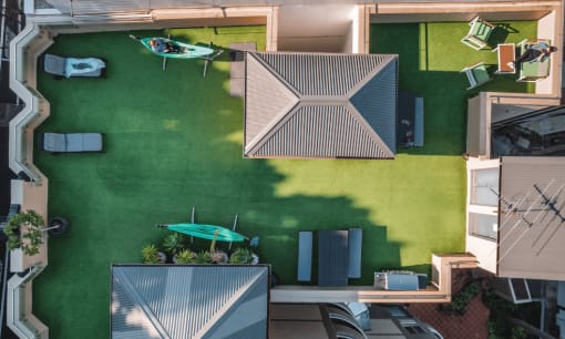 a birdseye view of the backyard of a house with a green lawn and