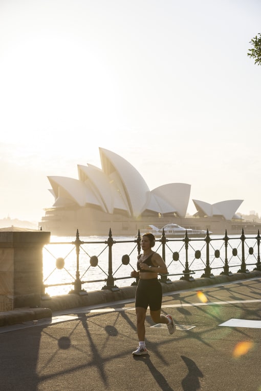 a man running in front of the opera house