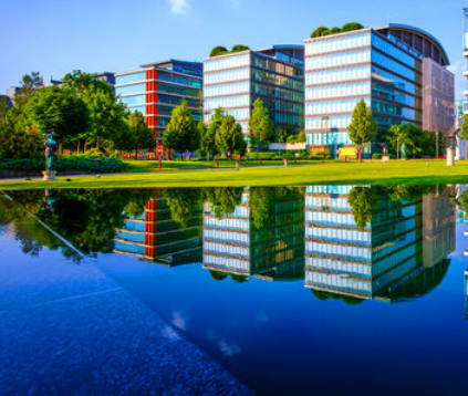 a reflection of a building in a body of water