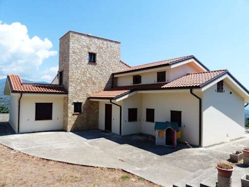 A house with a tower-like structure on the left side.