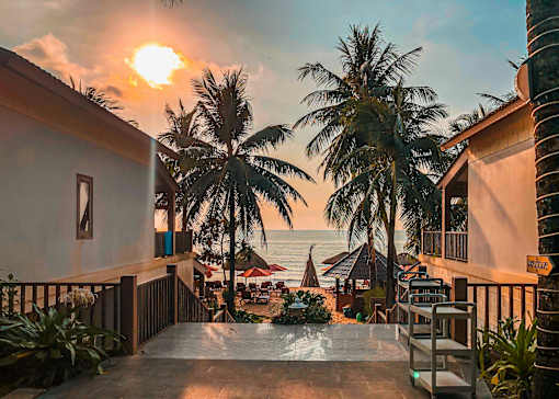 A sunset view from a balcony overlooking the ocean.