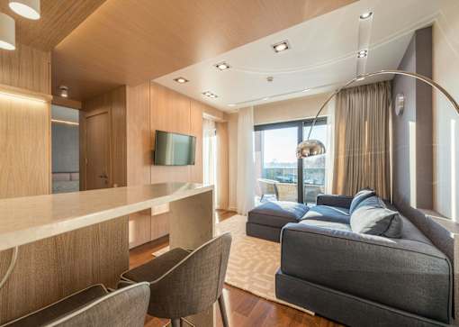 A modern living room with a grey sofa and wooden furniture.