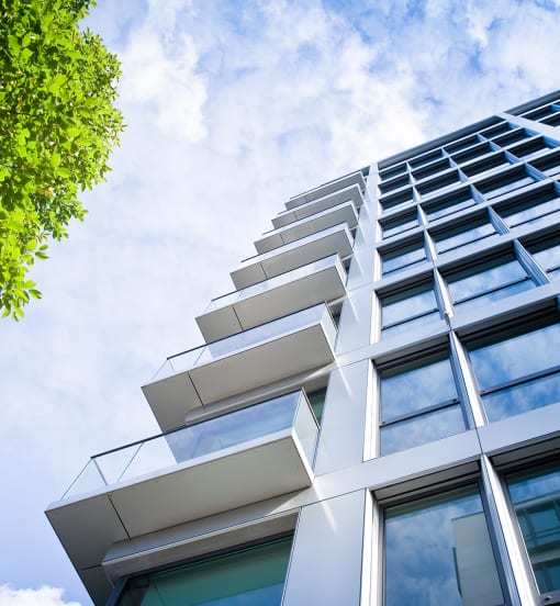 a close up of a tall building with glass balconies