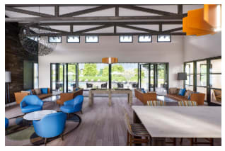 Clubhouse has leather chair and sofas, and a large table.