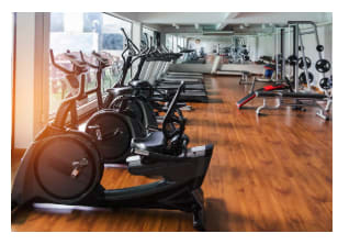 Rows of stationary bike and exercise equipment for bodybuilding in gym modern fitness center room