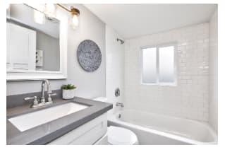 Modern bathroom interior with white vanity topped with gray countertop