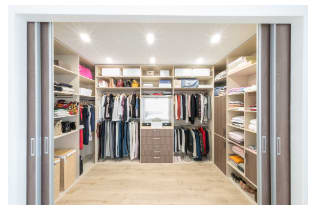 Spacious walk-in closet with shelves and center isle