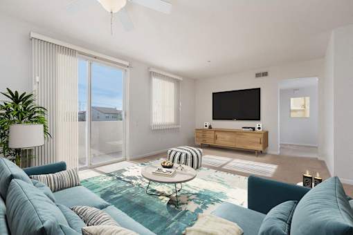A living room with a blue couch and a television.