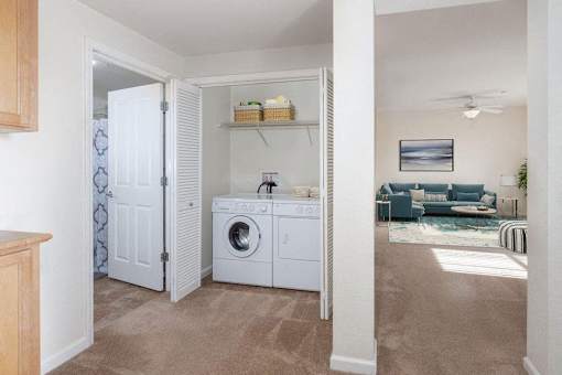 A laundry room with a washer and dryer is shown.