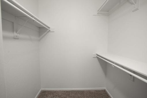 A white room with a carpeted floor and white walls.