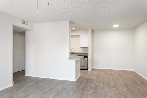 A kitchen area with a countertop and cabinets is visible.