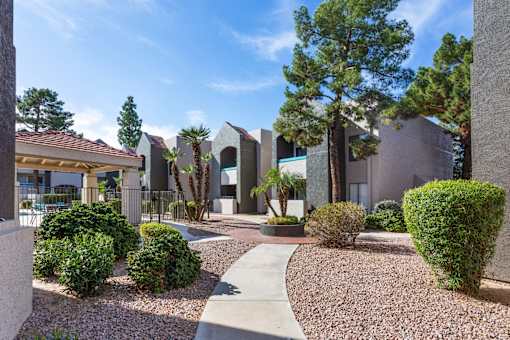 A modern building with a gravel pathway in front.