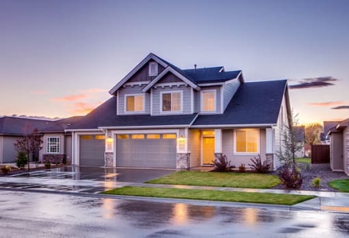 a house with two garages and a driveway