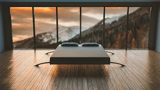 a bed in a bedroom with a mountain view