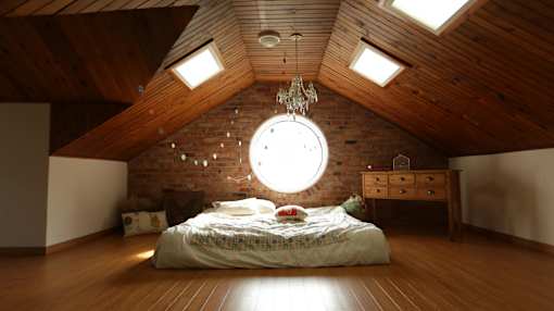a bedroom with a round window and a bed
