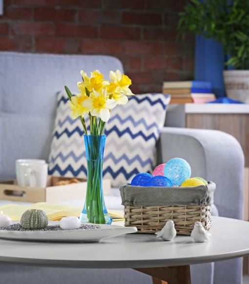 a table with eggs and a vase of yellow flowers