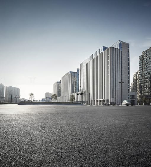 a city square with tall buildings in the background