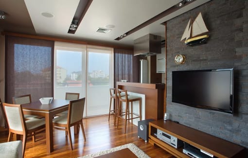 a living room with a television and a table and chairs