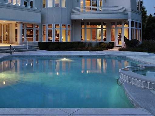 A large house with a pool in the backyard.