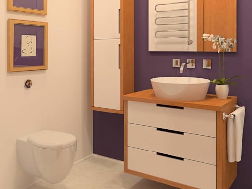 A bathroom with a toilet, sink, and purple walls.