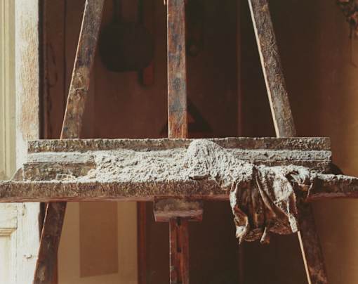 an old wooden chair with a cloth on it