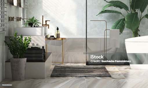 A modern bathroom with a marble countertop and a large mirror.