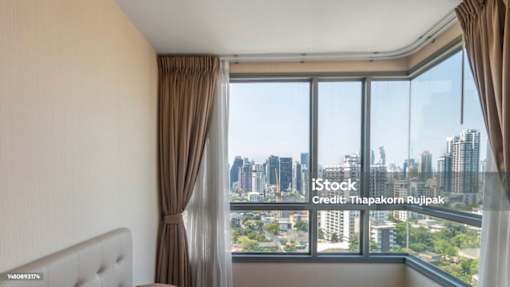 A room with a large window overlooking a cityscape.