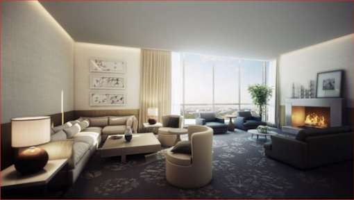 A modern living room with a fireplace and a view of the cityscape outside the window.