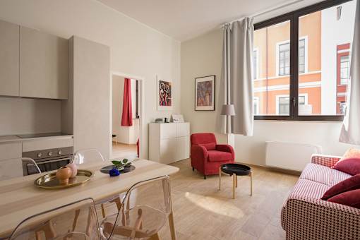 a small apartment with a dining area and a living room