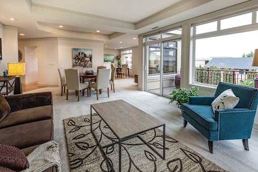 a living room filled with furniture and a large window