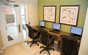 a desk with three computer monitors on top of it