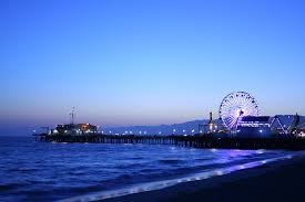 a ferris wheel on a pier next to the ocean