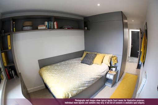 a bedroom with a bed and a book shelf