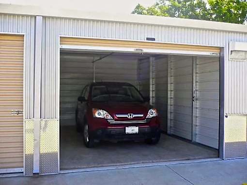 a red car is parked in a garage