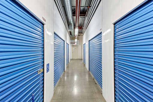 a row of closets with blue doors in a hallway