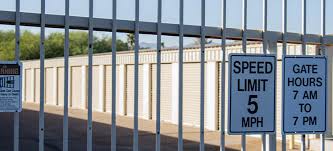 two speed limit signs on the side of a fence