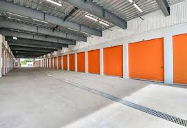 the inside of an empty garage with orange doors