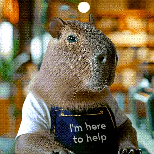 A guinea pig wearing a blue apron with the text "I'm here to help" on it.