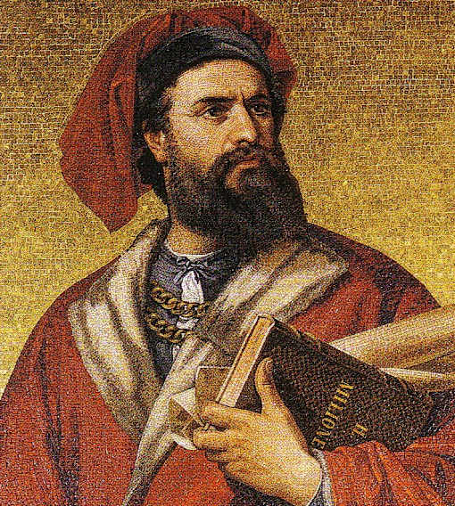 A man with a beard and wearing a red hat is holding a book.