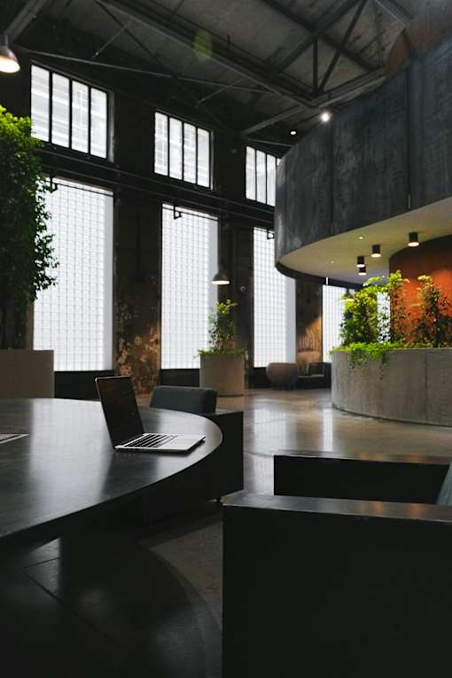 A modern office space with a laptop on a table.