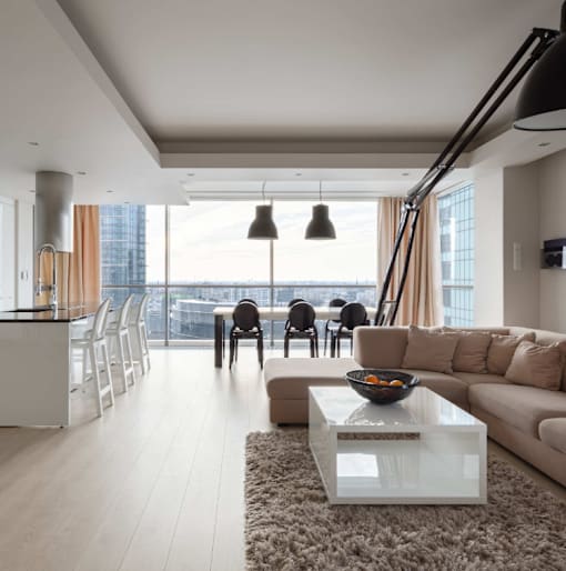 A modern living room with a large window overlooking the city at Bluebell Ridge, Denver 80202