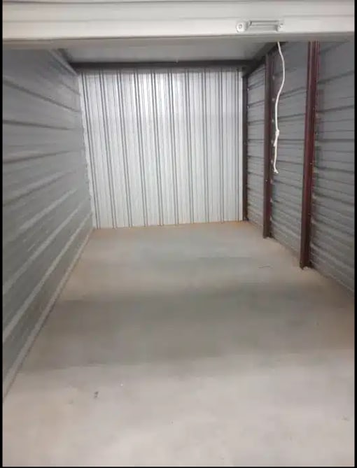 the inside of a garage with a concrete floor