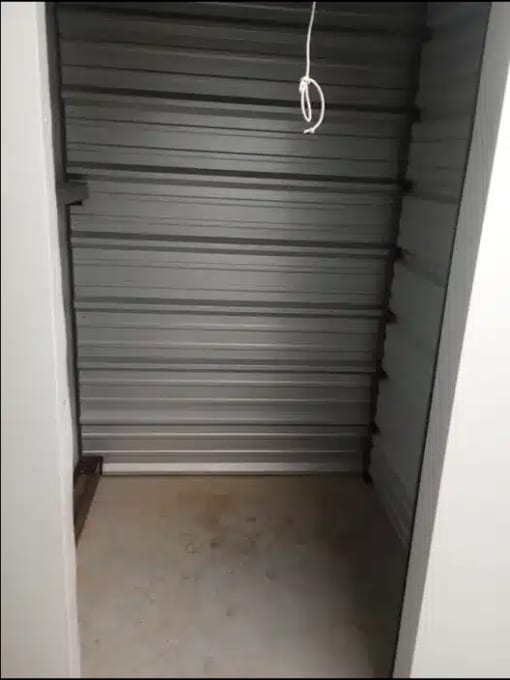 a grey garage door with a rope hanging from it